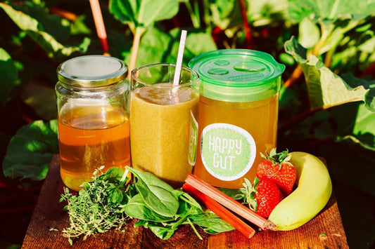 Fresh ingredients accompany jars and glasses of this smoothie