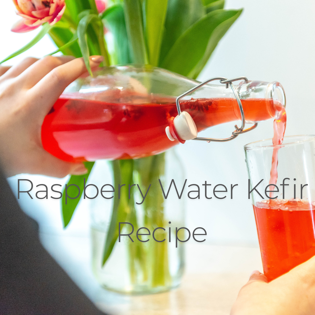 Deliciously red raspberry water kefir being poured into a glass