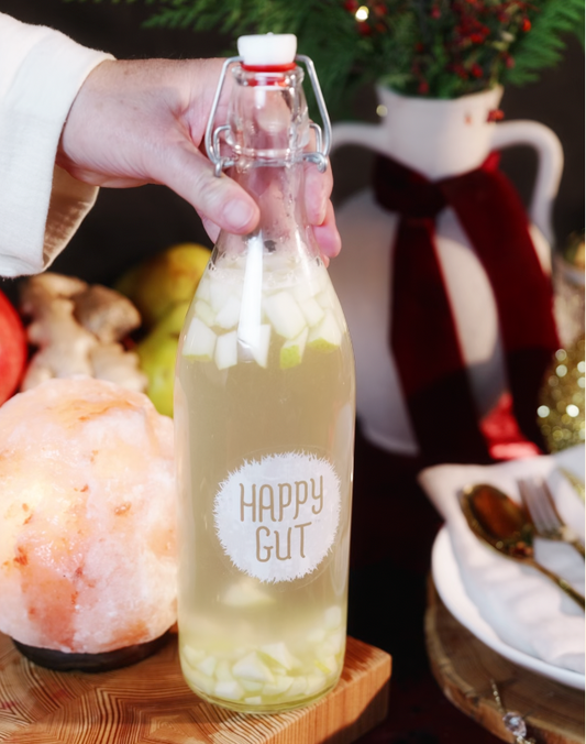 A bottle of fresh pear & ginger slices in water kefir